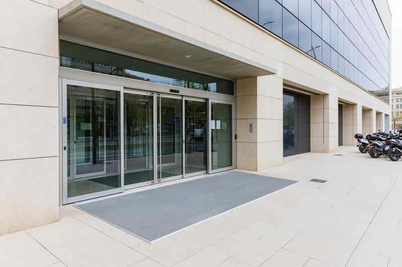 Automatic glass doors at the entrance of a modern corporate office building