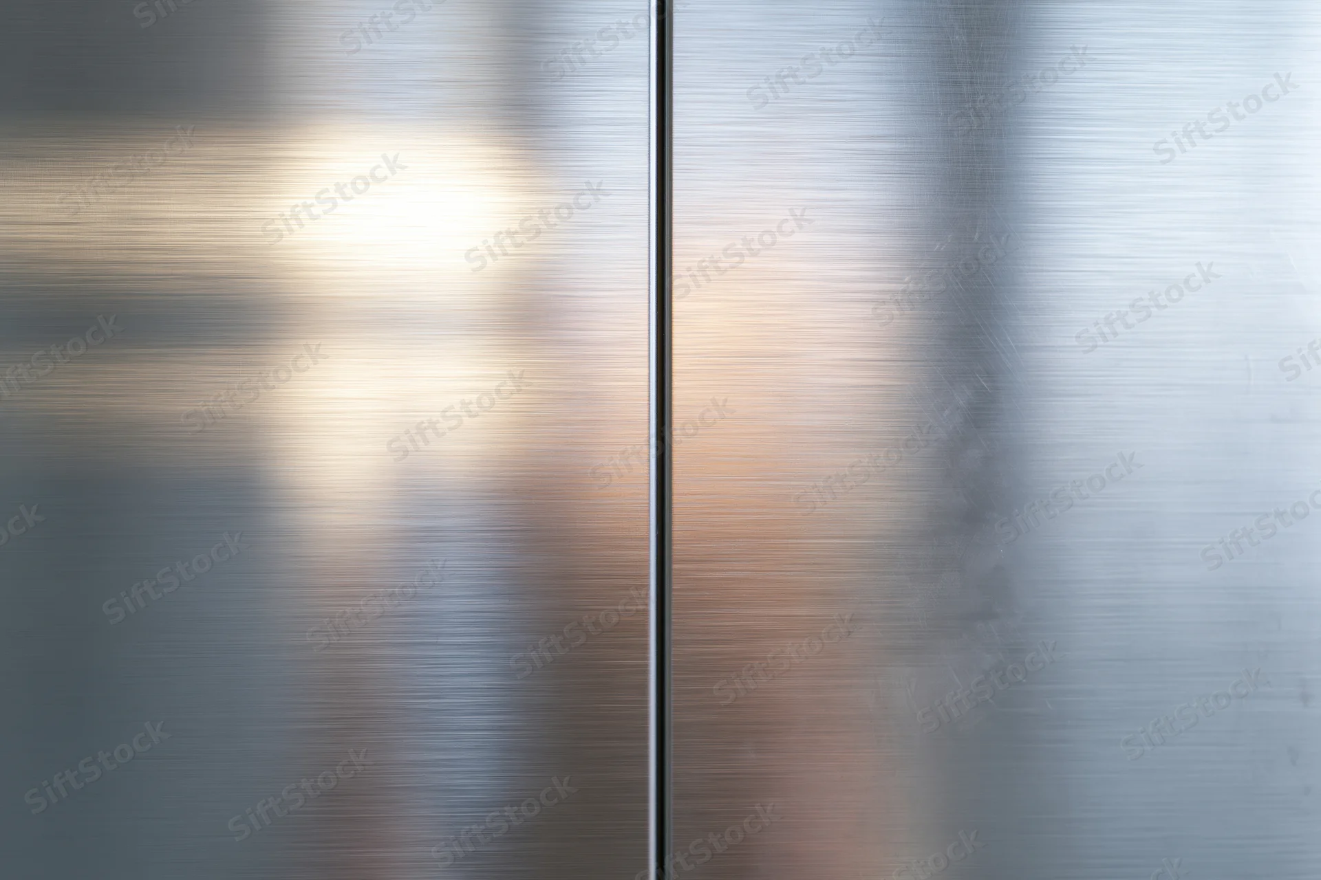 Two brushed stainless steel panels meeting at a vertical seam