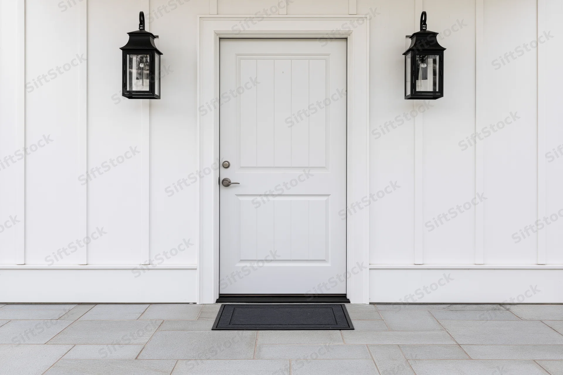 White front door with raised panel design centered on a house exterior