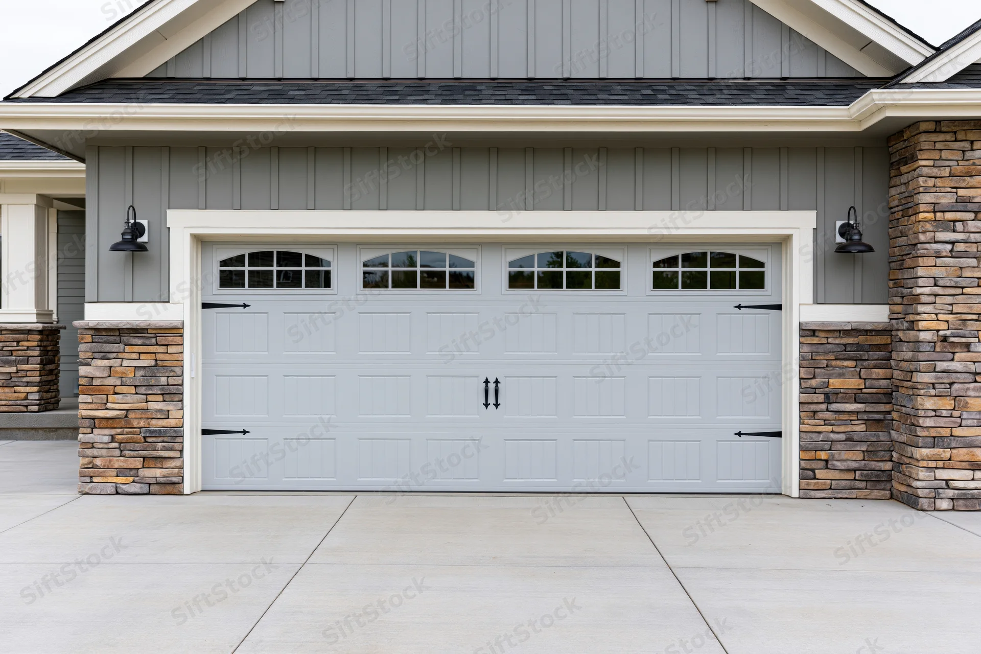 Wide two-car garage door on suburban craftsman-style home exterior