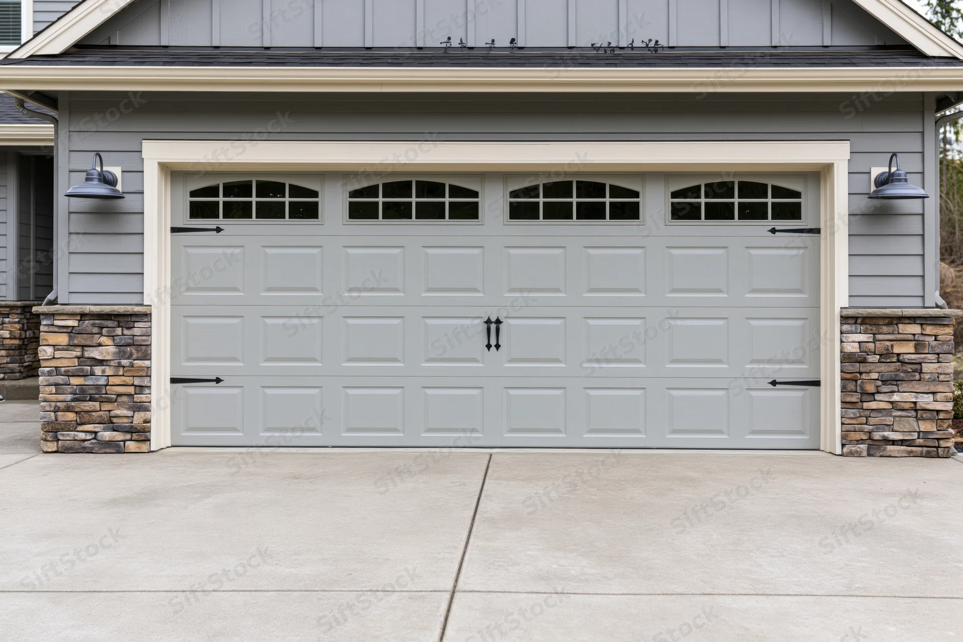 Wide two-car garage door on suburban craftsman-style home exterior