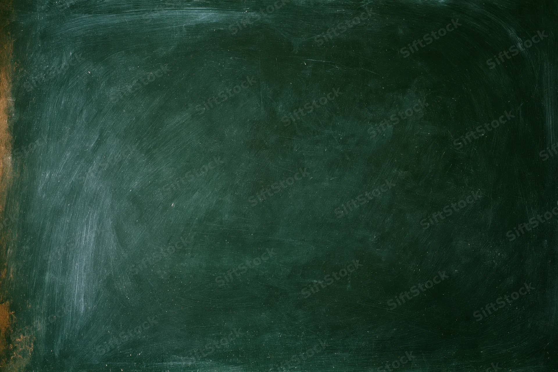 Worn dark green chalkboard surface filling the frame with smudged marks and dust residue