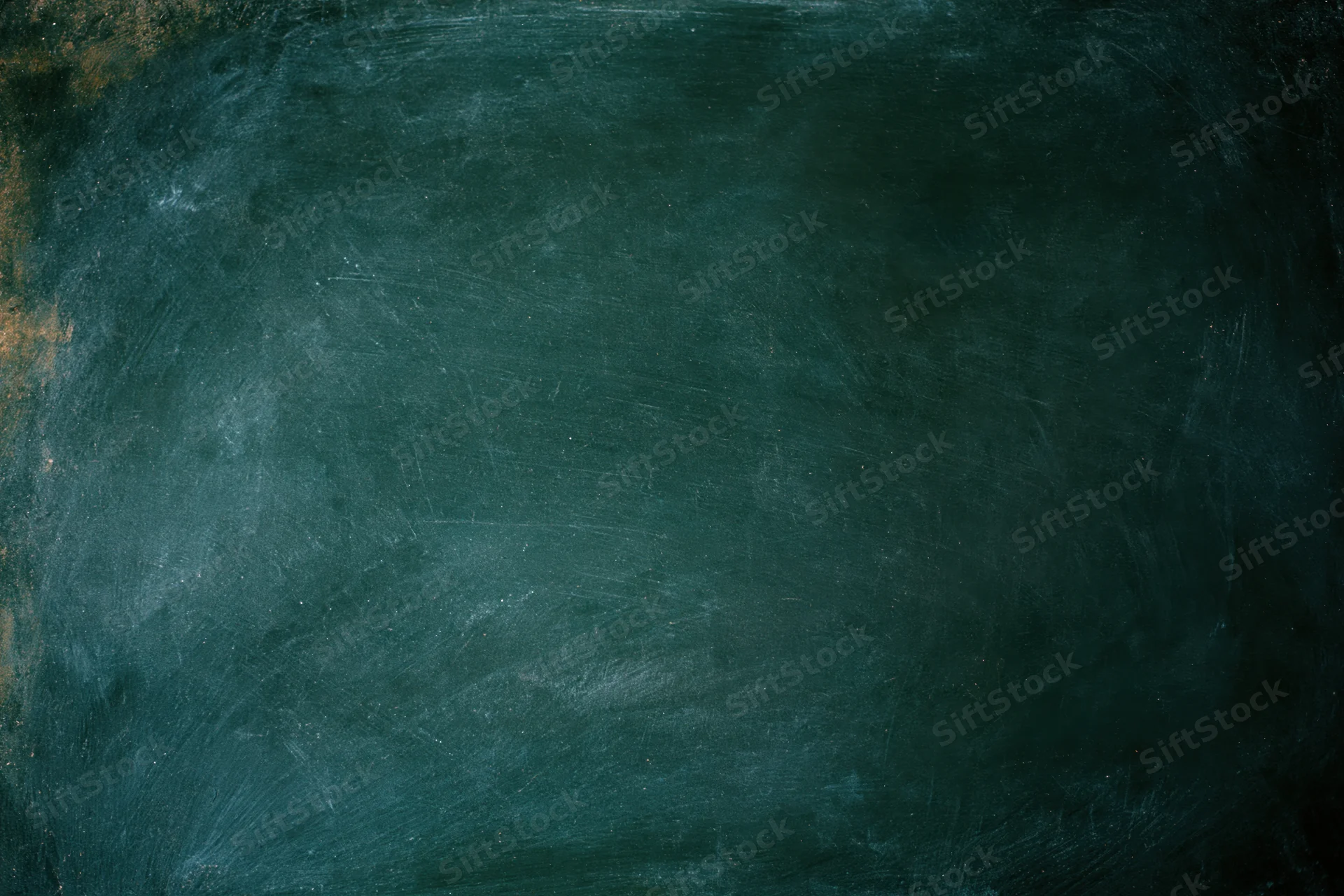 Worn dark green chalkboard surface filling the frame with smudged residue and scratches