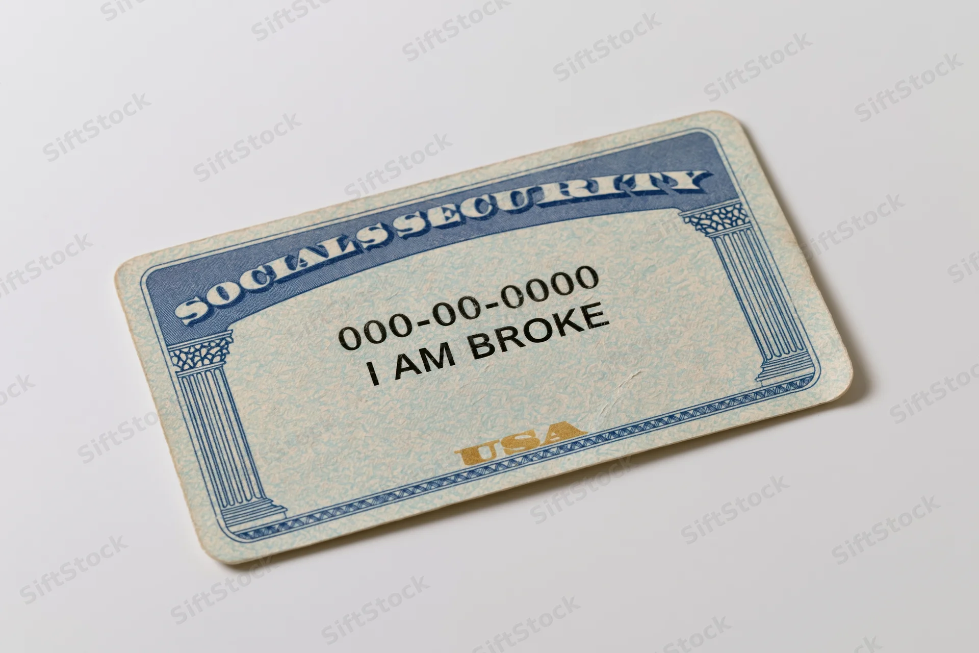 Us social security card with text i am broke lying flat on white surface