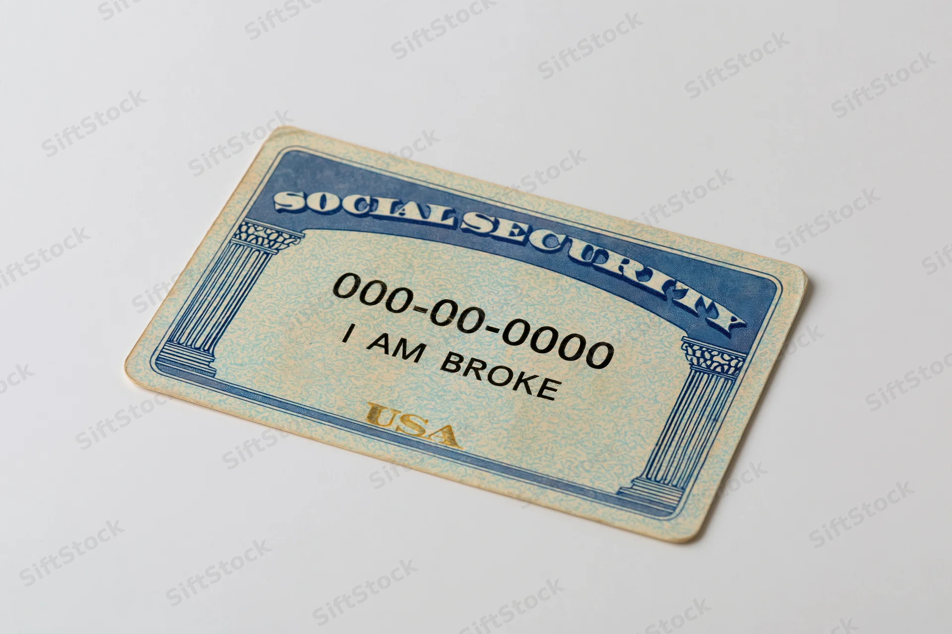 Us social security card with text i am broke lying flat on white surface