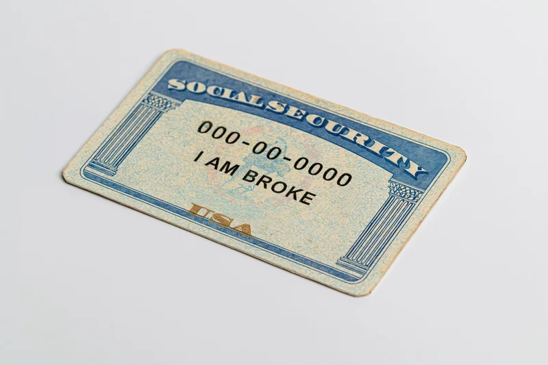 Us social security card with text i am broke lying flat on white surface