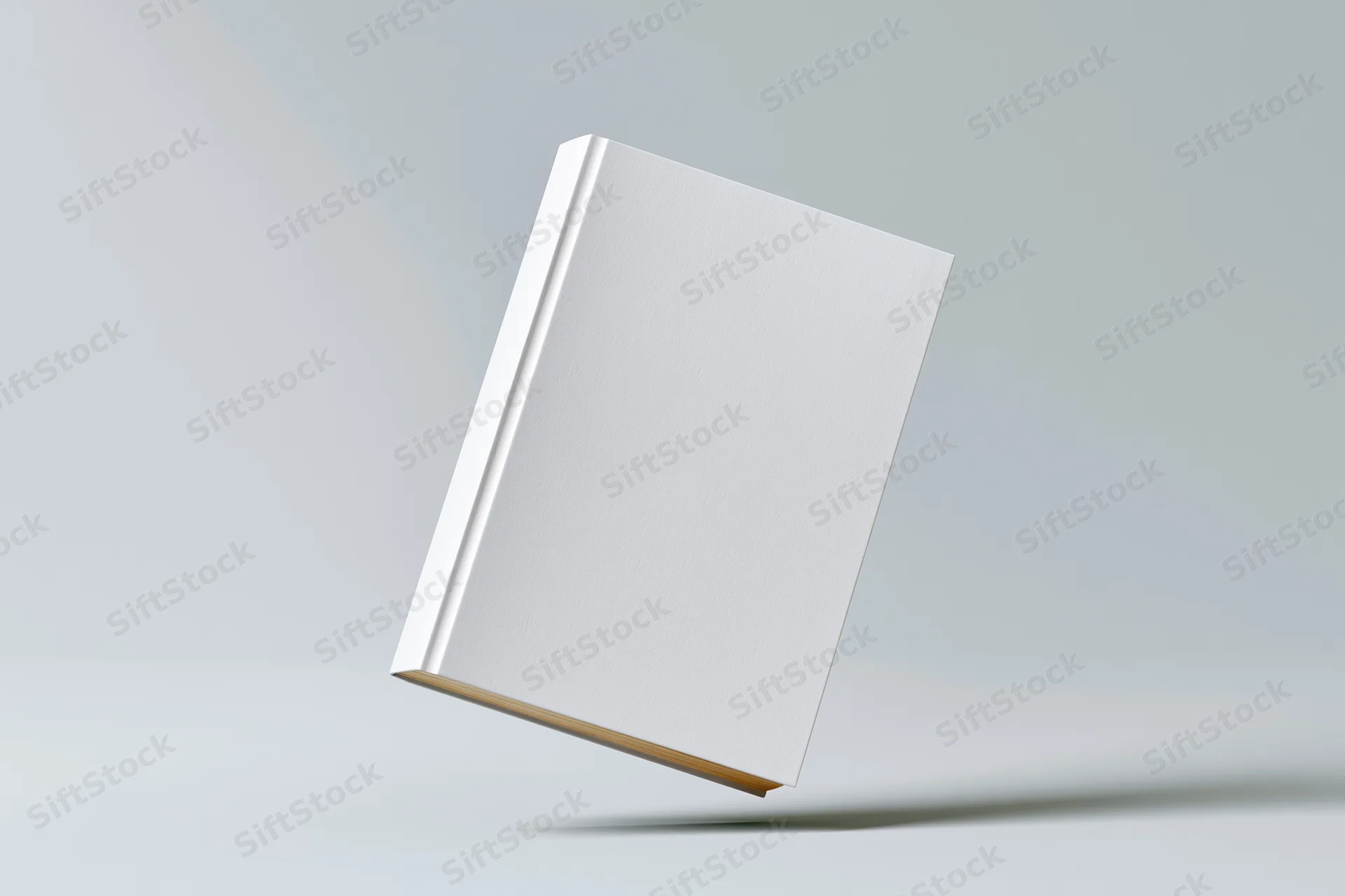 Blank white hardcover book standing slightly tilted on a neutral gray surface
