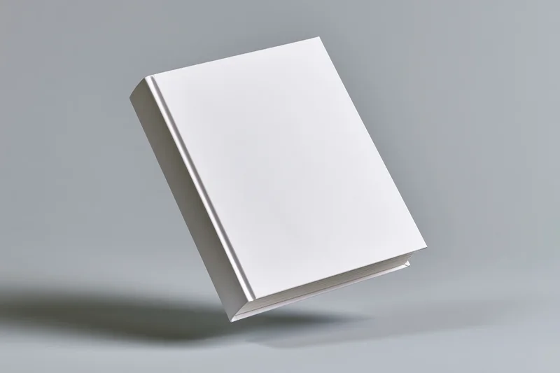 Blank white hardcover book standing slightly tilted on a gray surface