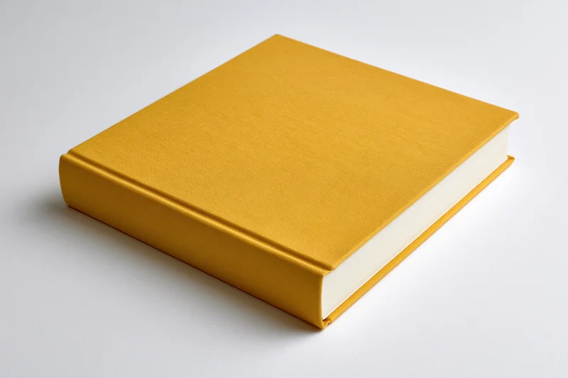 Mustard-yellow hardcover book with plain cloth cover on white surface