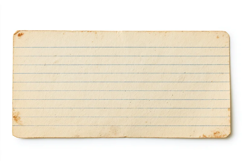 Aged blank lined index card lying flat on white background