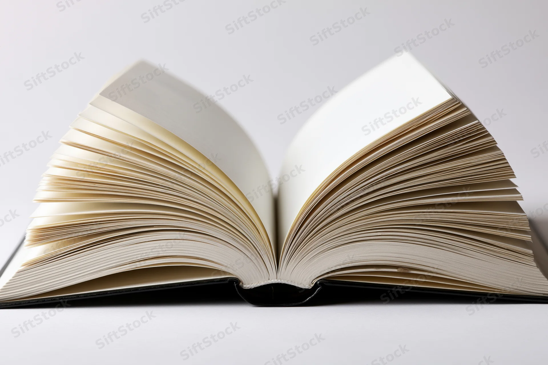 Open hardcover book with pages fanned outward symmetrically on white background