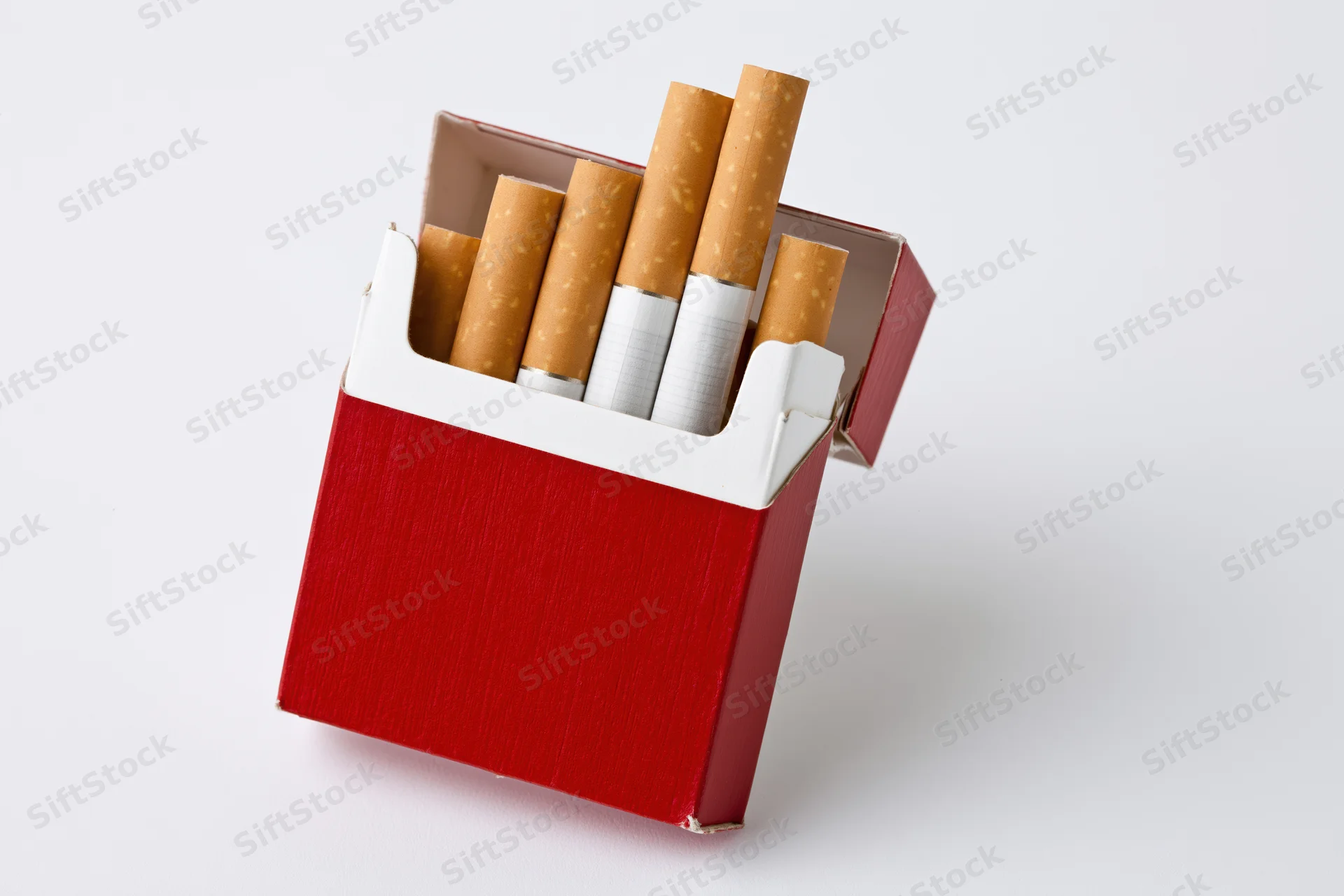 Open red and white cigarette pack with several cigarettes visible against white background