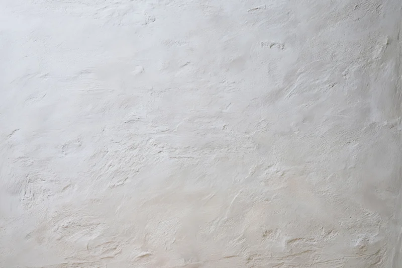 Textured white concrete wall surface filling the frame