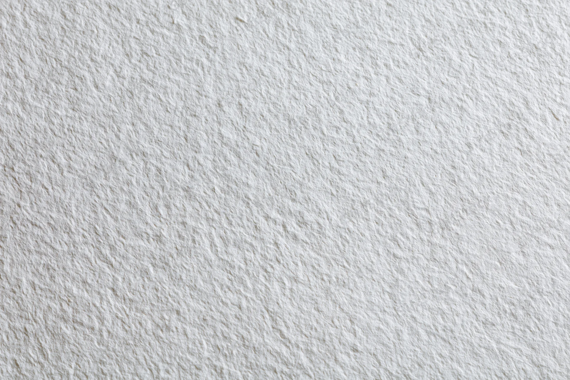 Close-up of a blank sheet of cold-press watercolor paper showing its textured surface