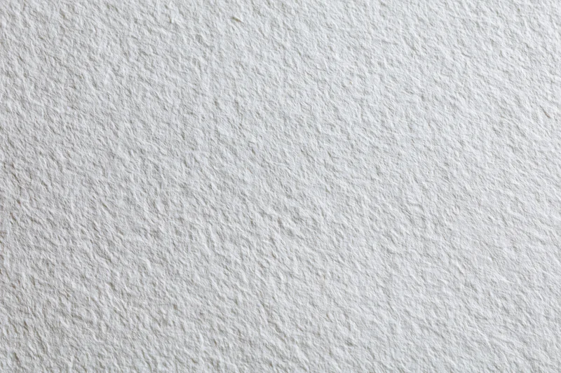 Close-up of a blank sheet of cold-press watercolor paper showing its textured surface