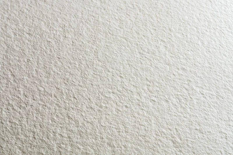 Close-up of textured white paper surface for artistic use