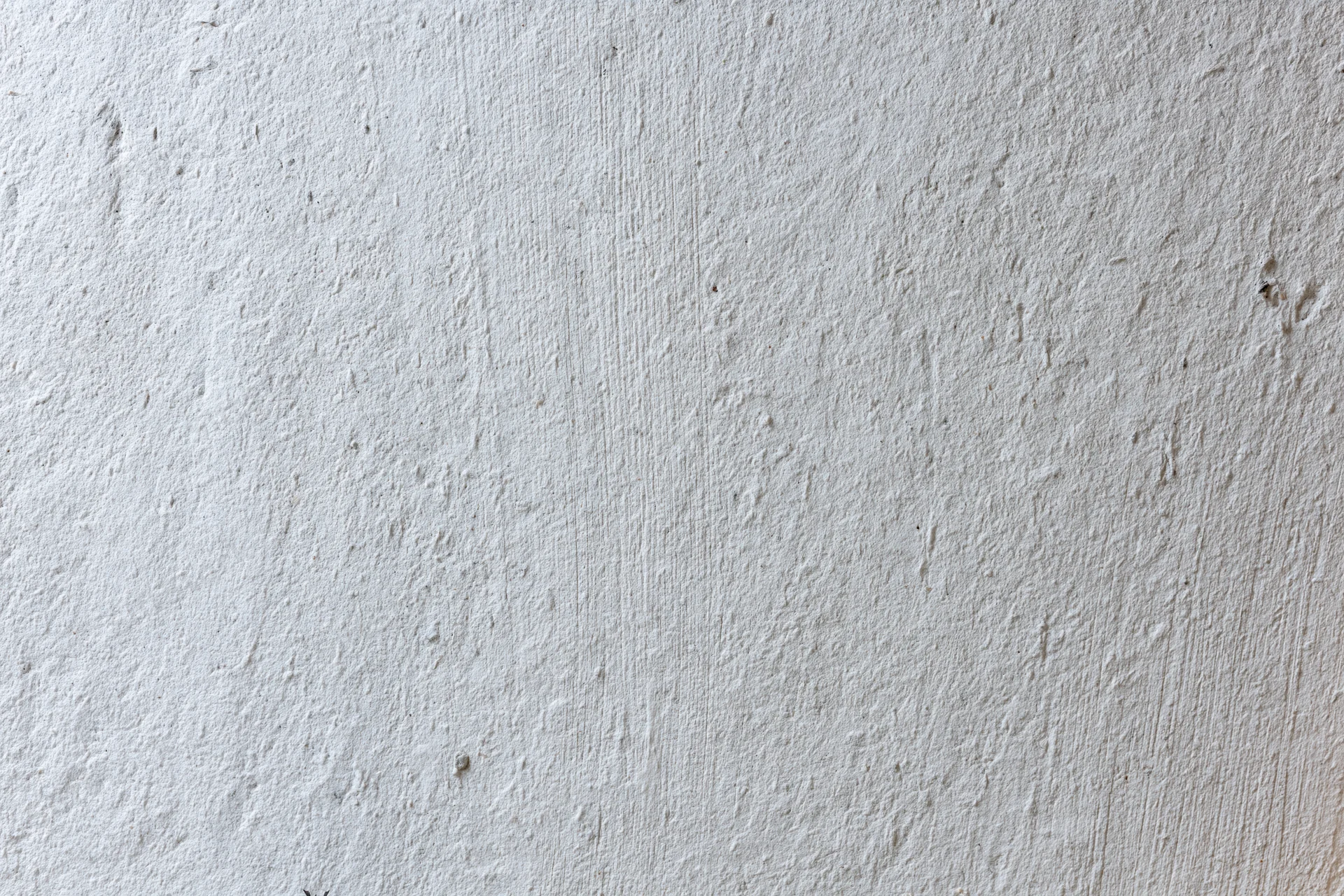 Close-up of a textured concrete wall surface showing rough gray finish with minor imperfections