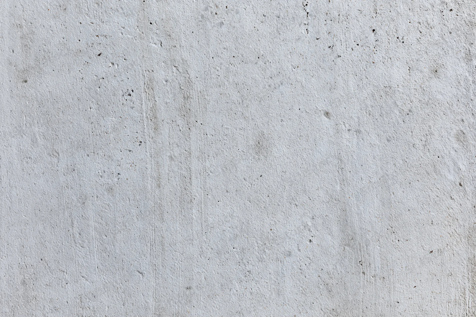 Close-up of a smooth concrete wall surface with subtle texture and gray tone