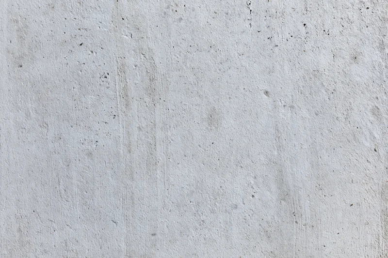 Close-up of a smooth concrete wall surface with subtle texture and gray tone