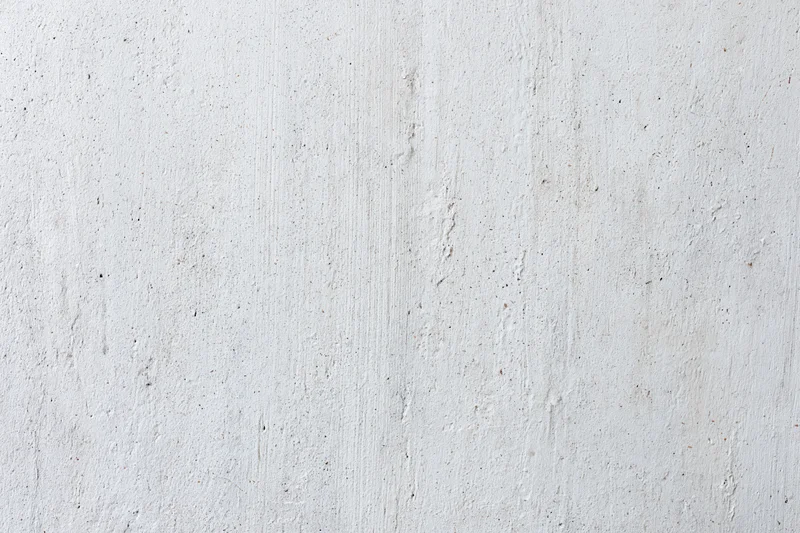 Close-up of a weathered concrete wall surface with visible texture and minor imperfections