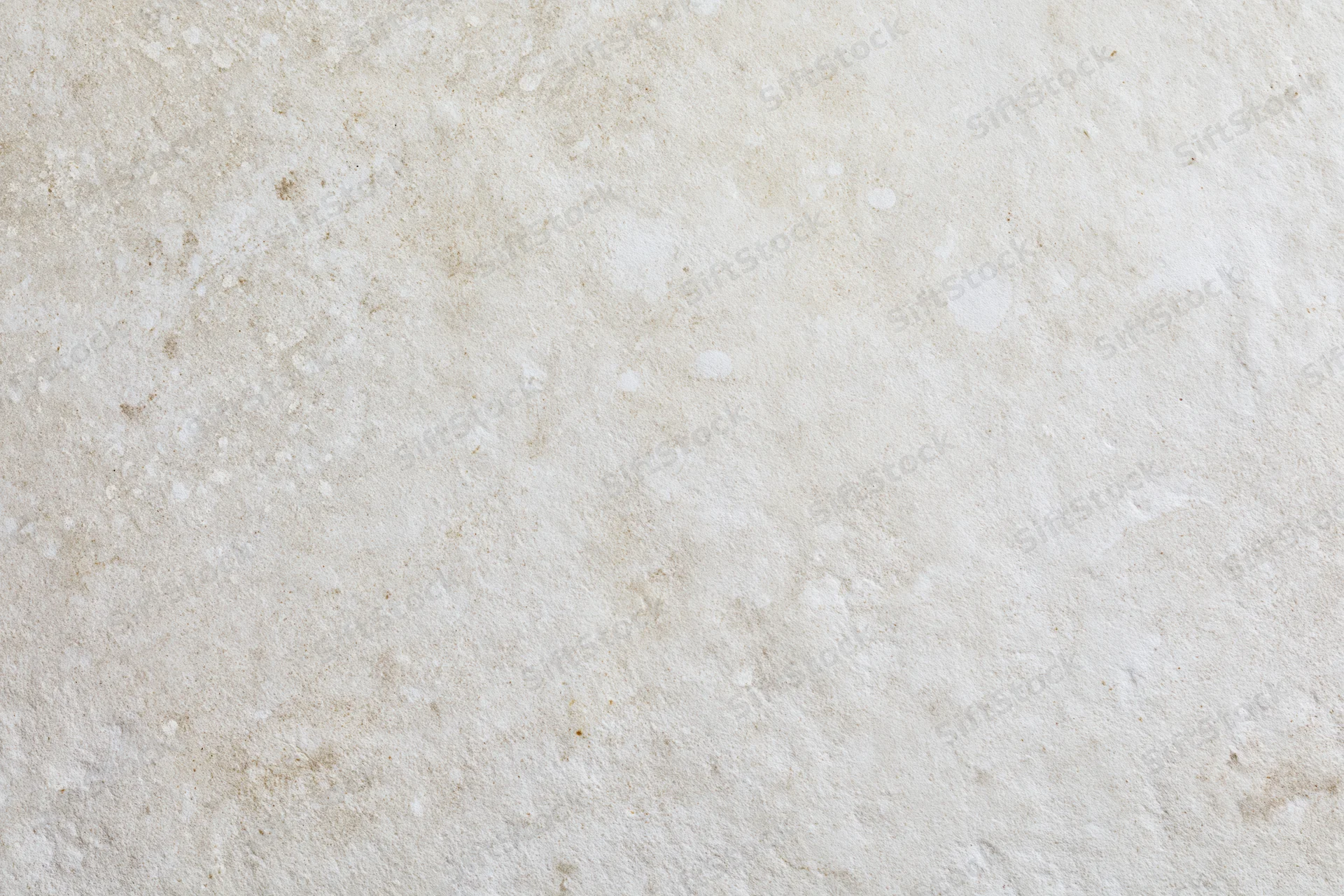 Close-up of a smooth limestone or concrete surface with natural texture and neutral beige tone