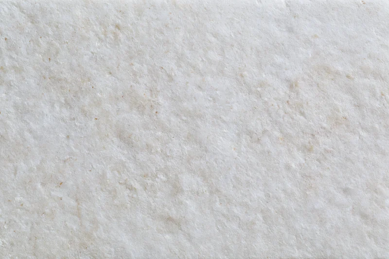 Close-up of smooth limestone or concrete surface with natural veining and neutral tone