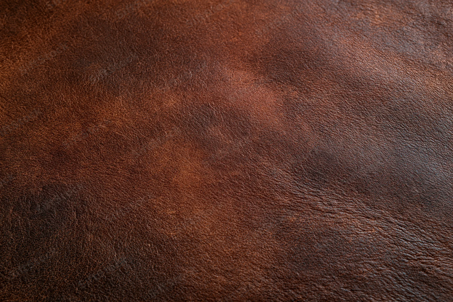Close-up of dark brown full-grain leather surface showing natural texture and grain pattern