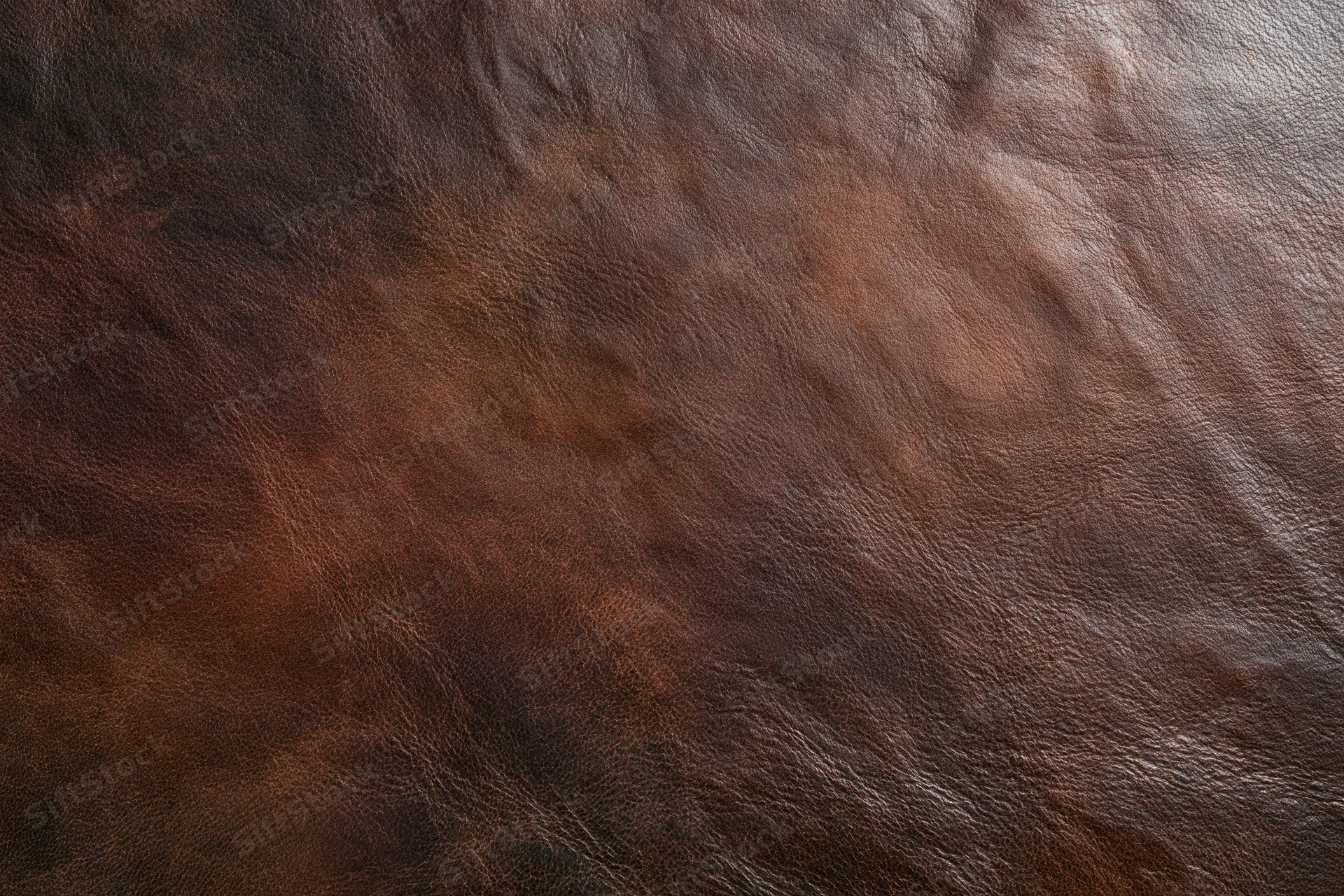 Close-up of dark brown full-grain leather surface showing natural texture and grain pattern