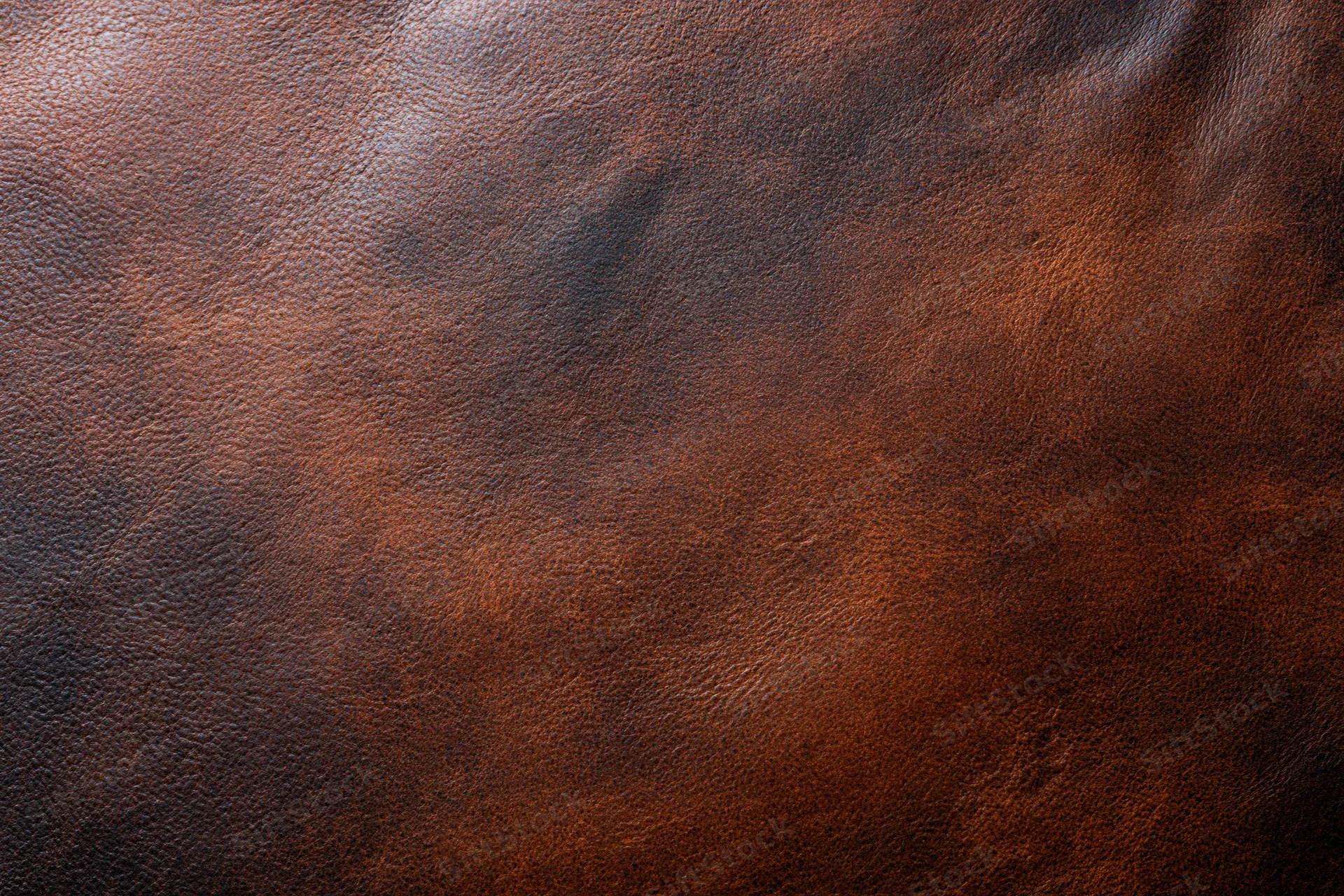 Close-up of dark brown full-grain leather surface showing natural texture and grain pattern