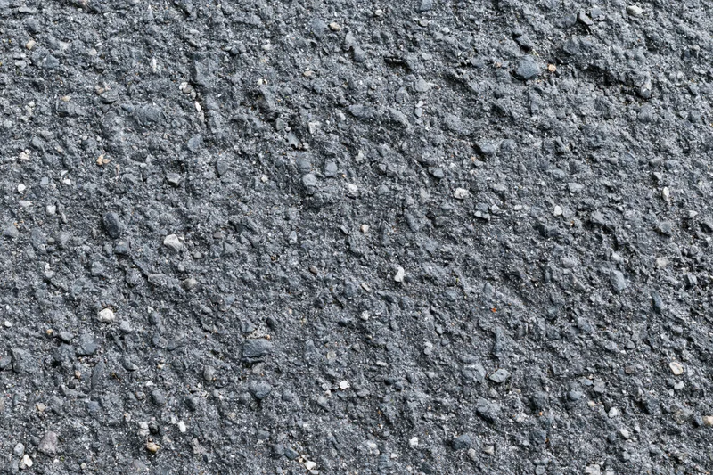 Close-up of rough asphalt road surface filling the frame