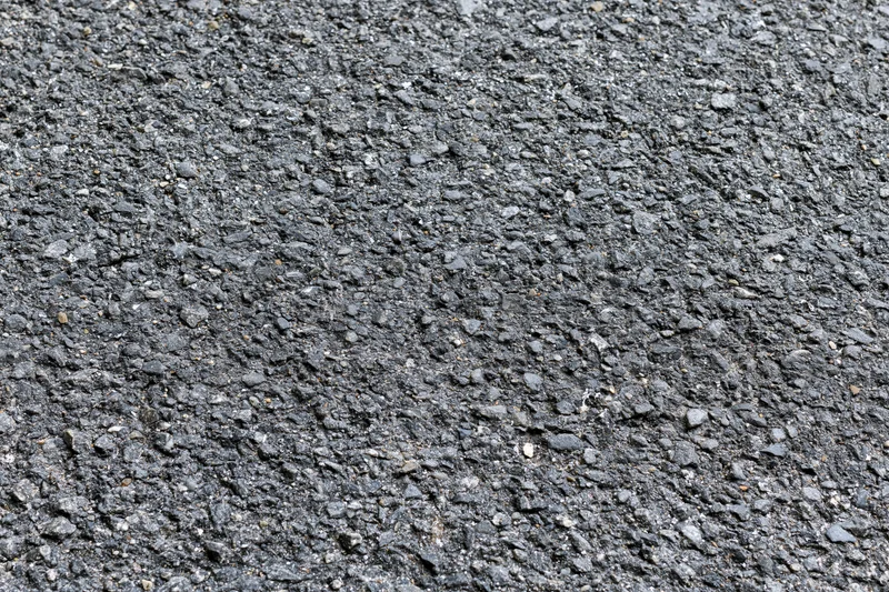Close-up of rough asphalt road surface filling the frame