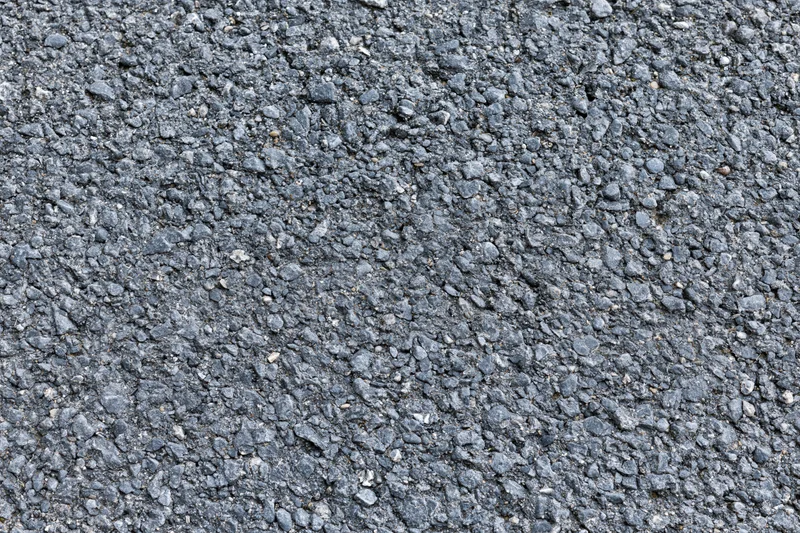Close-up of rough asphalt road surface filling the frame