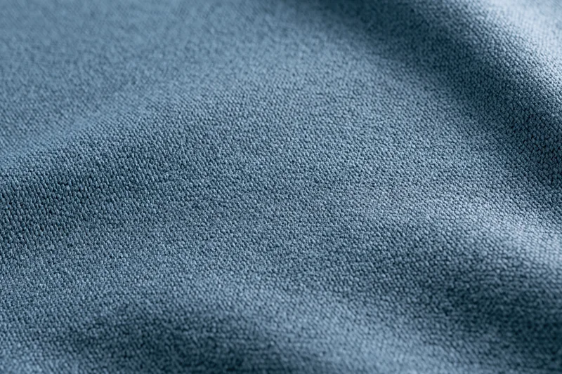 Close-up of steel-blue textured fabric with visible weave pattern filling the frame