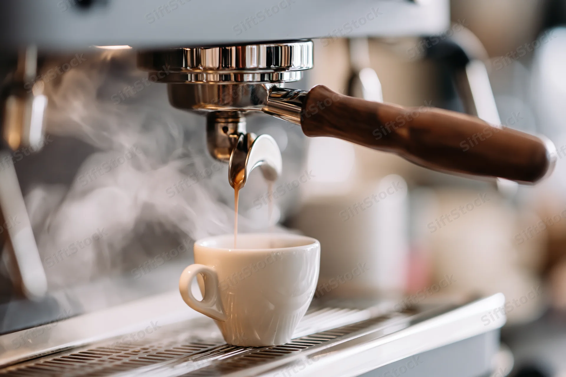 Espresso machine extracting coffee into a white ceramic cup on a drip tray