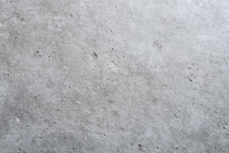 Close-up of a rough gray concrete wall surface filling the frame