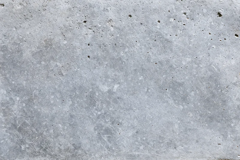 Close-up of a rough gray concrete wall surface filling the frame