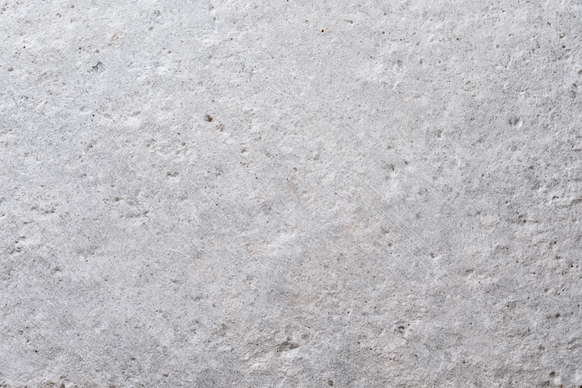 Close-up of a rough gray concrete wall surface filling the frame