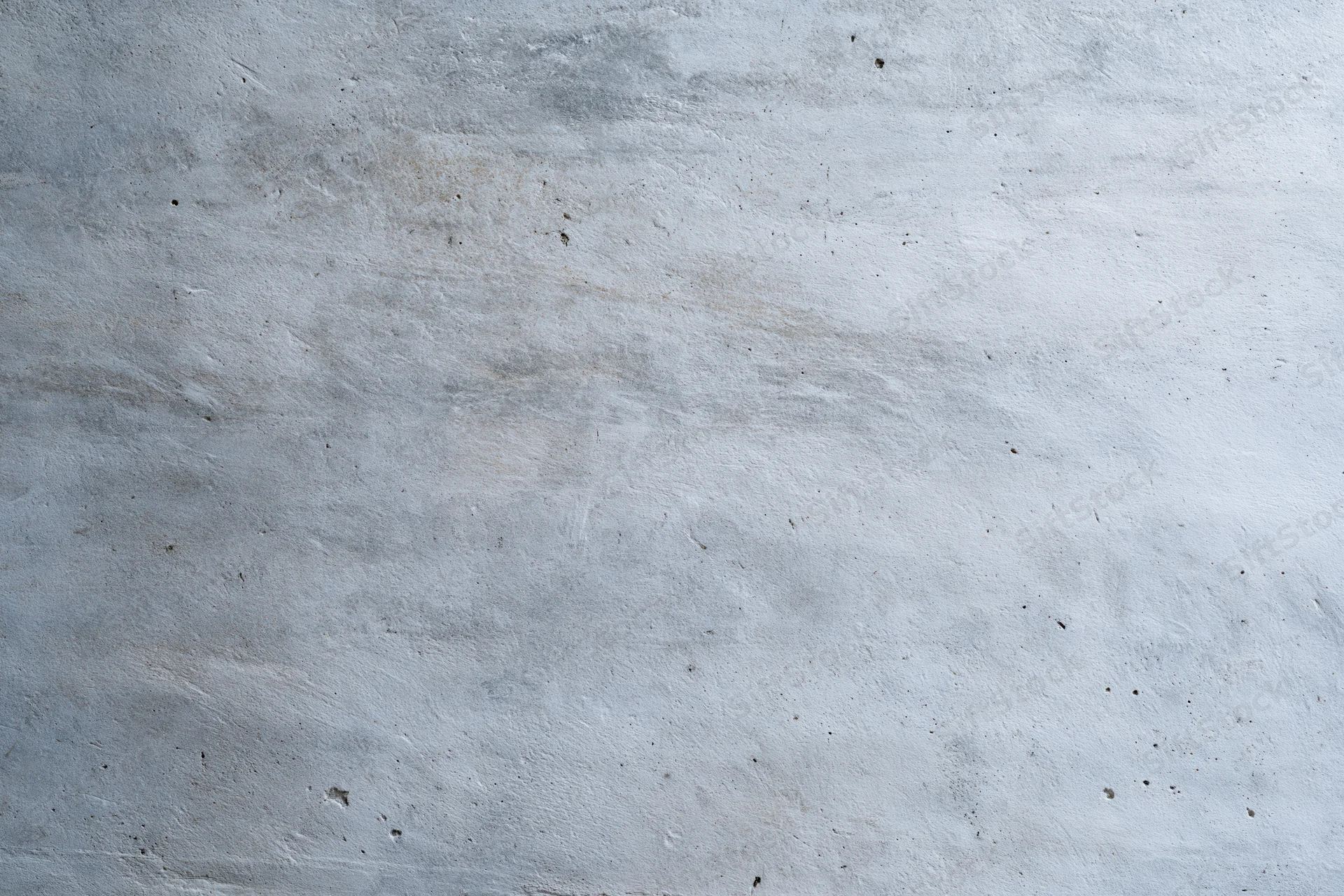 Close-up of a weathered concrete wall surface with visible texture and minor imperfections