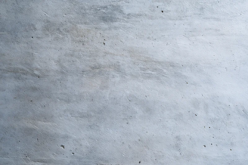 Close-up of a weathered concrete wall surface with visible texture and minor imperfections