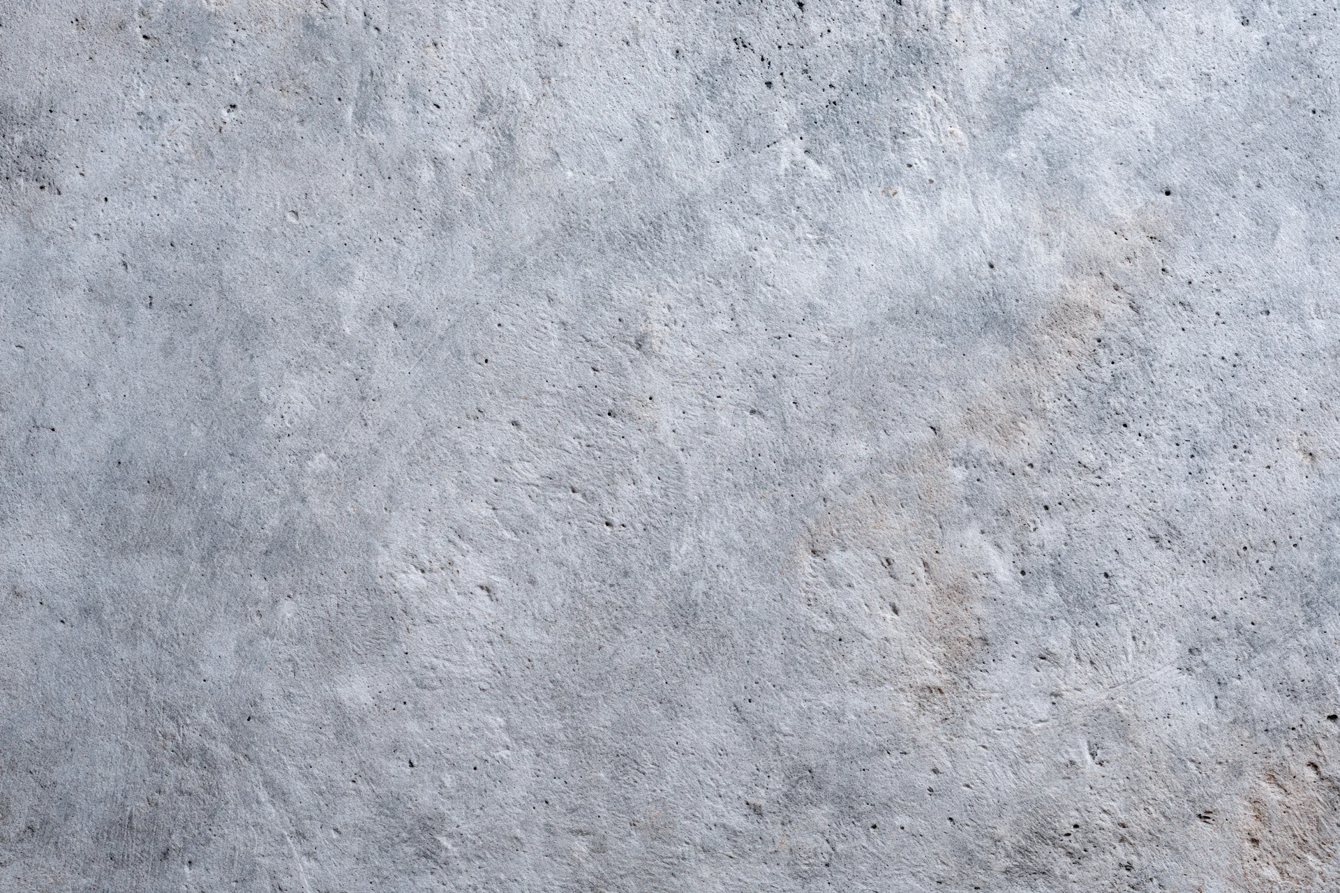 Close-up of a rough gray concrete wall surface filling the frame