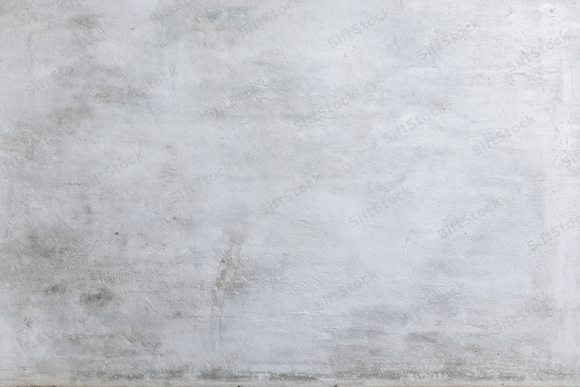 Close-up of a weathered concrete wall surface with visible texture and minor imperfections