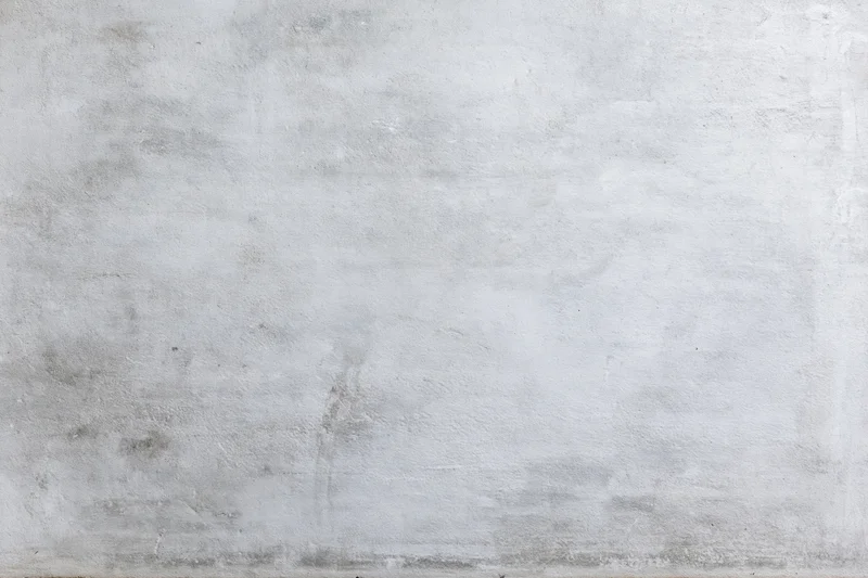Close-up of a weathered concrete wall surface with visible texture and minor imperfections