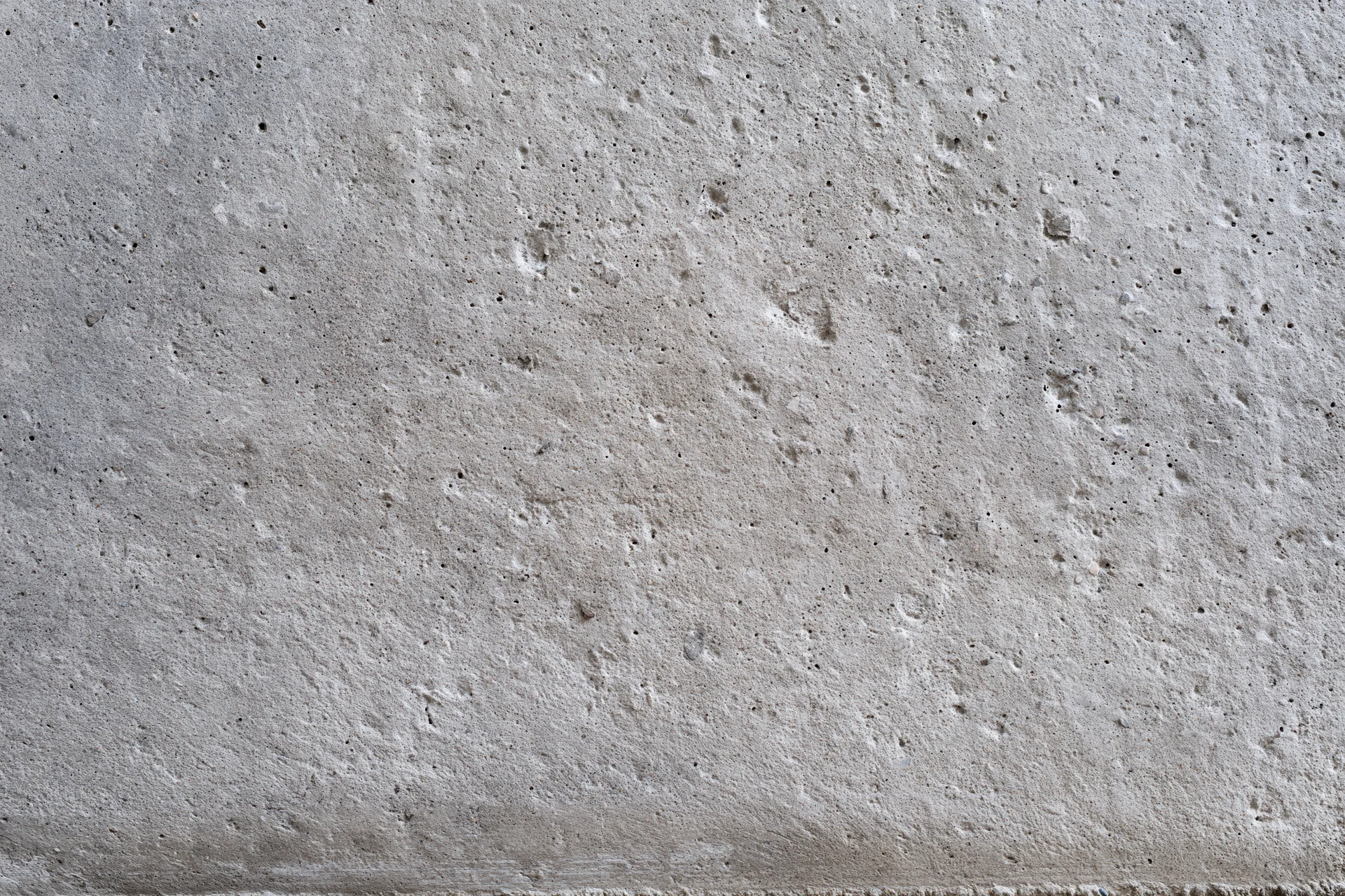 Close-up of a rough gray concrete wall surface