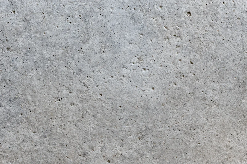 Flat concrete surface filling the frame with rough texture and small pits