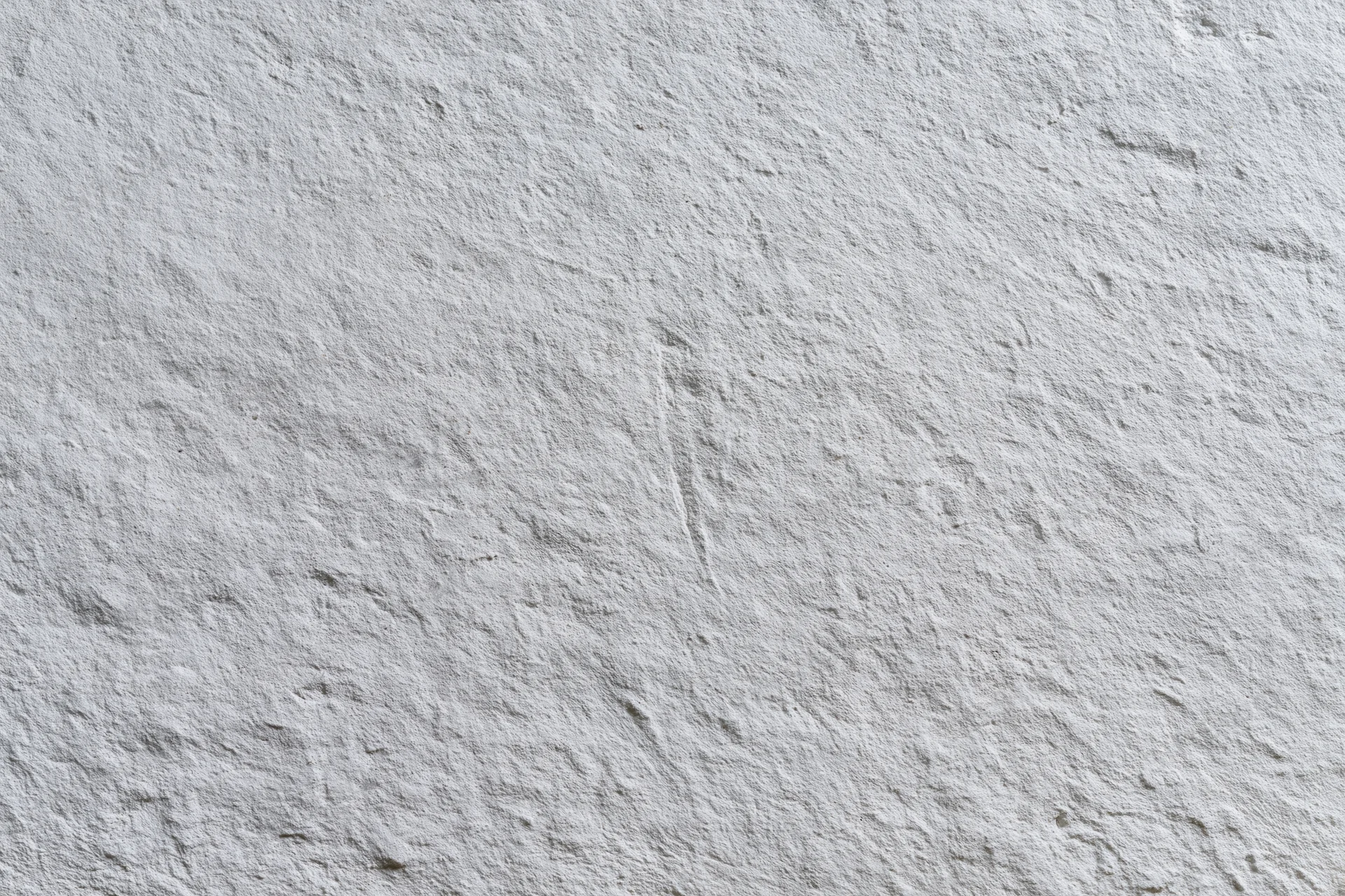Close-up of a rough gray concrete wall surface filling the frame