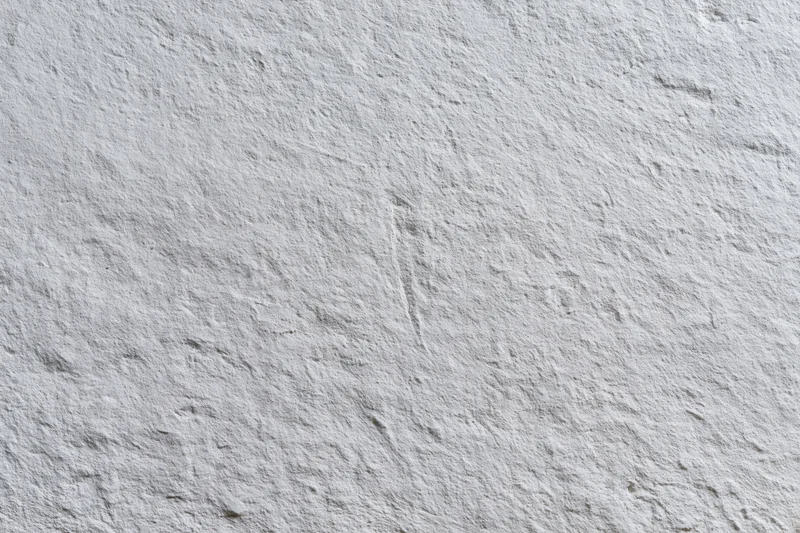 Close-up of a rough gray concrete wall surface filling the frame