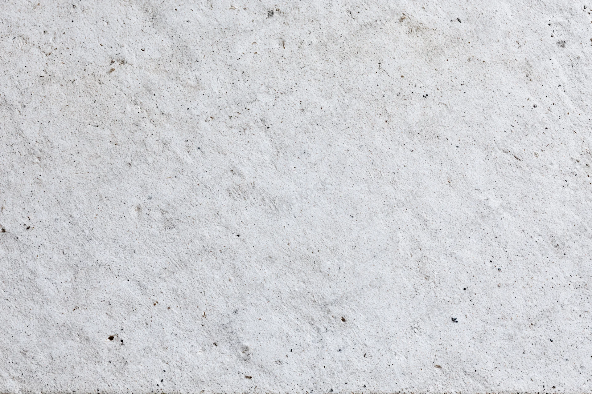 Close-up of a rough gray concrete wall surface filling the frame