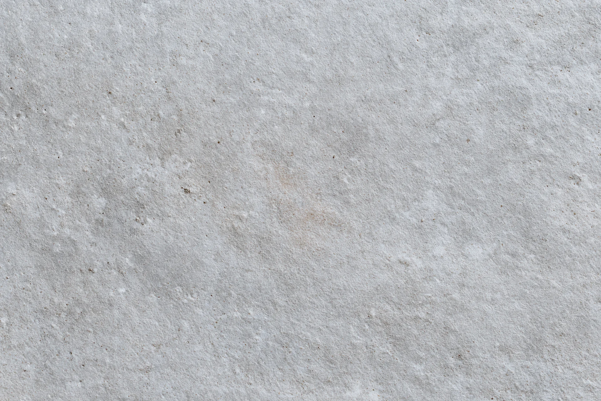 Close-up of a rough gray concrete wall surface filling the frame