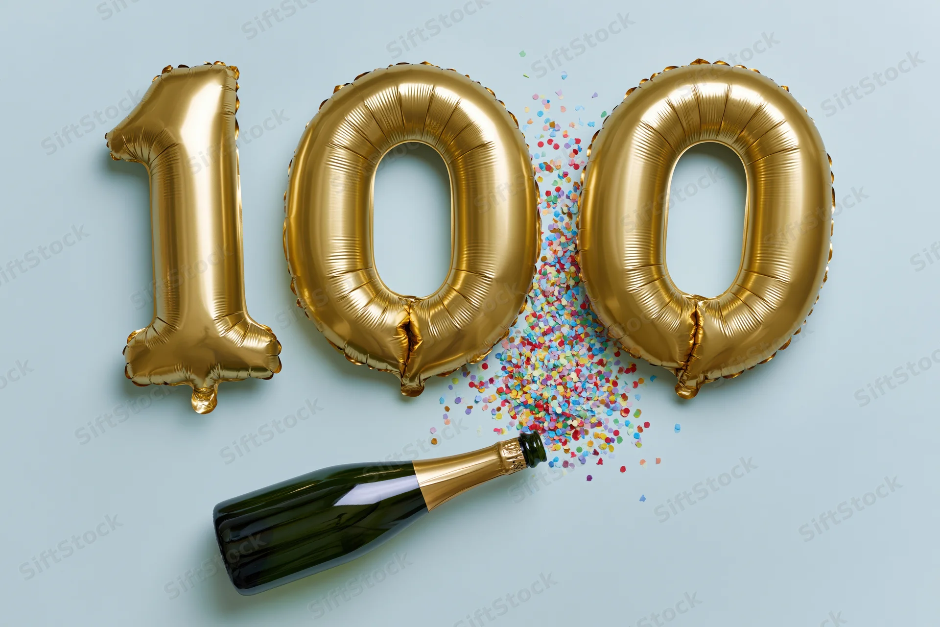 Gold foil number 100 balloons with champagne bottle and confetti on light blue background