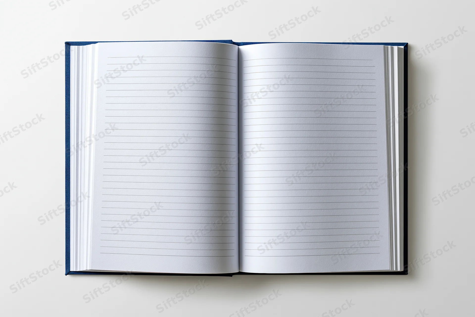 Open hardcover notebook with lined pages lying flat on white surface